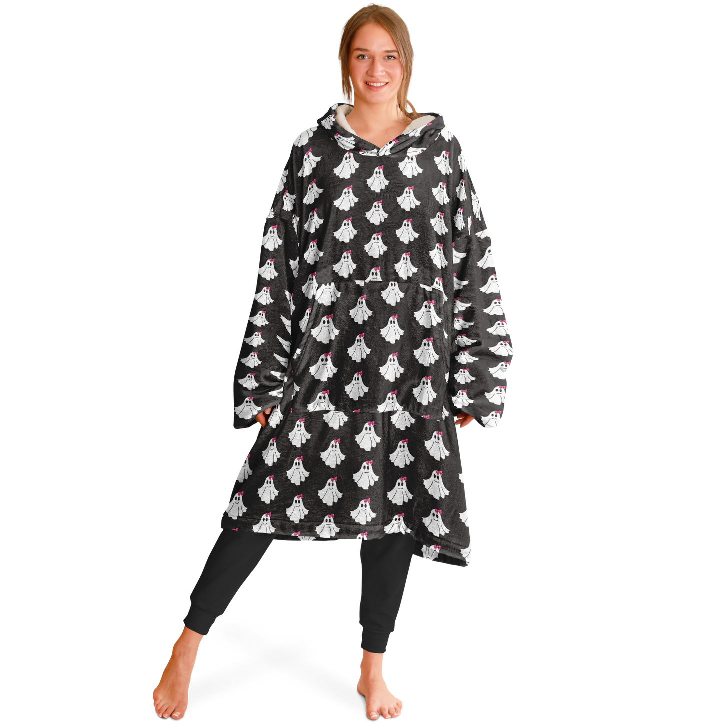 Woman wearing a black poncho with ghost patterns on a white background