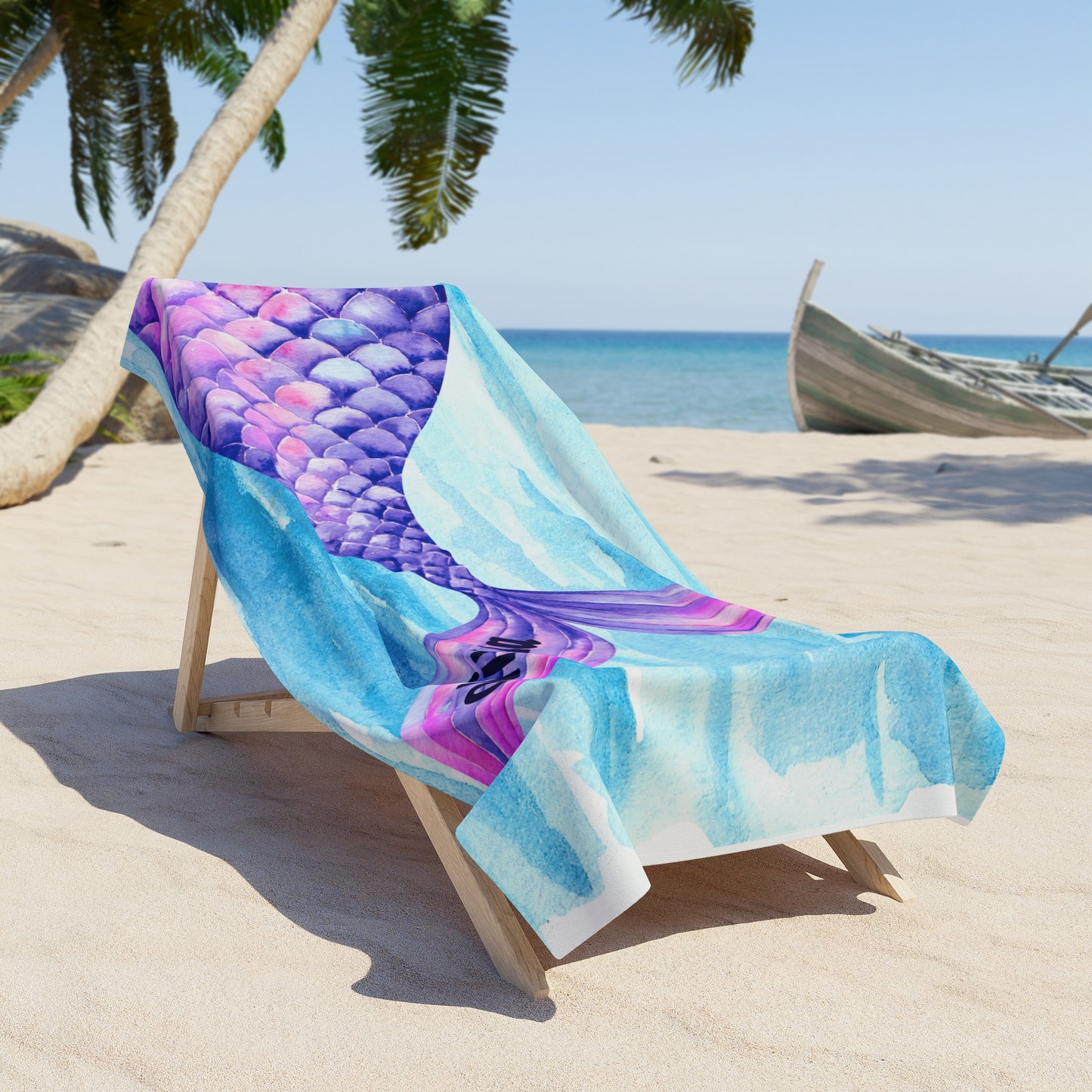 Colorful mermaid tail towel on a beach chair with palm trees and ocean in the background