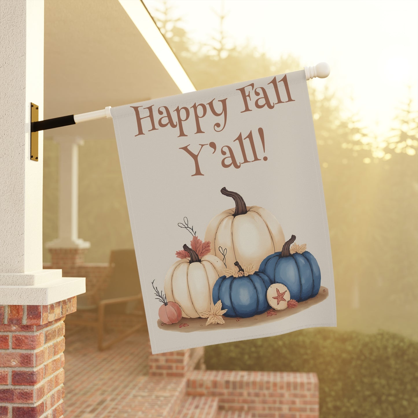 Decorative flag with pumpkins and 'Happy Fall Y'all!' text hanging on a porch.