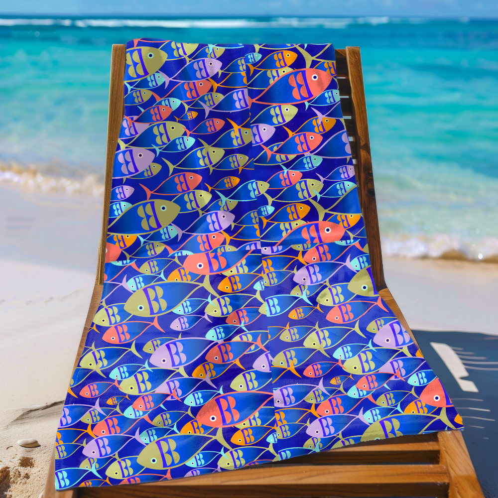 Colorful fish-patterned towel on a wooden chair by the beach
