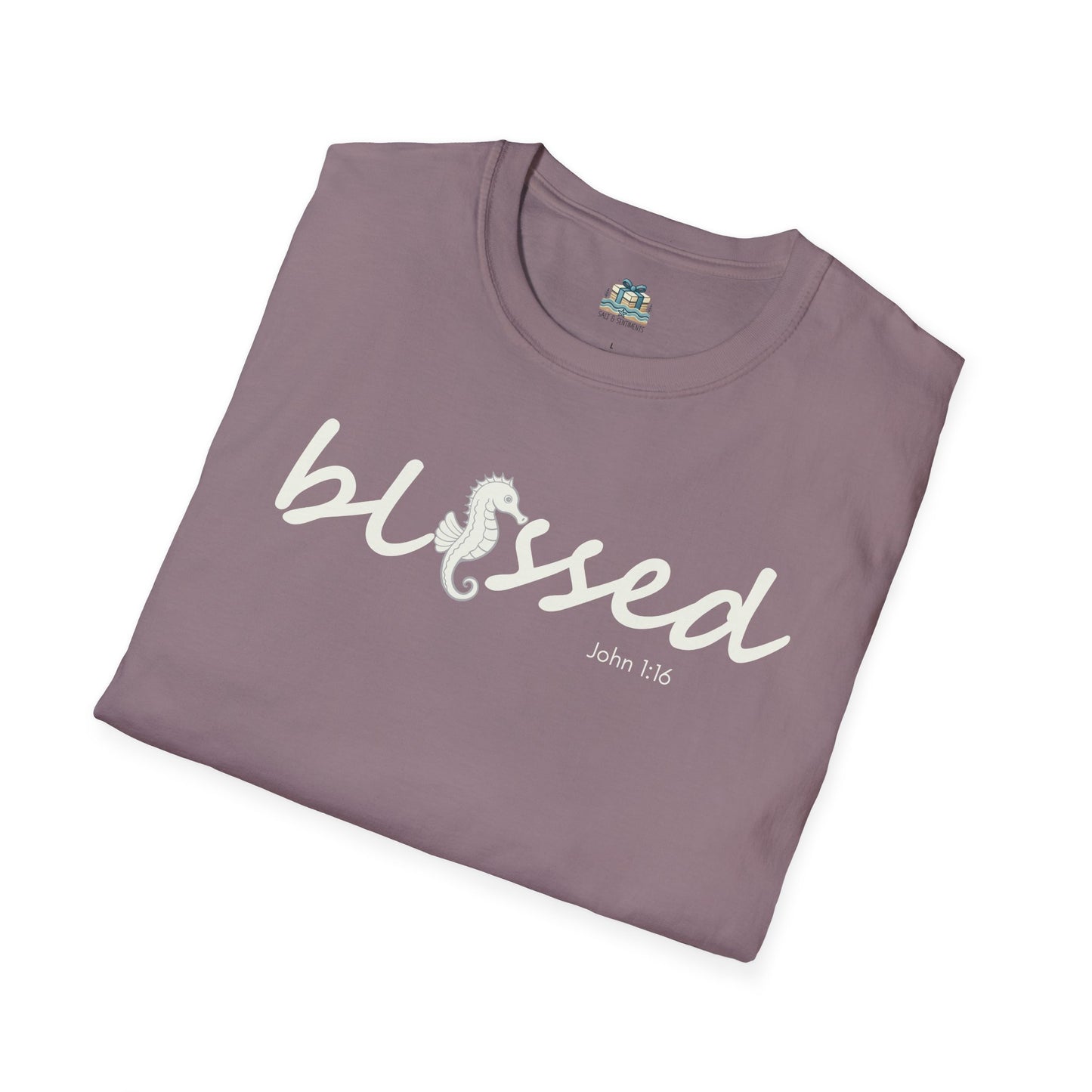 Folded purple t-shirt with 'blessed' text on a white background