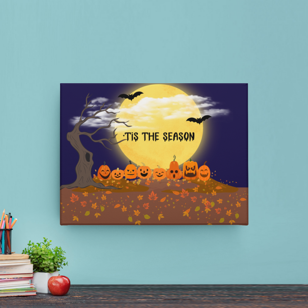 Halloween-themed wall art with pumpkins and moon on a blue wall.