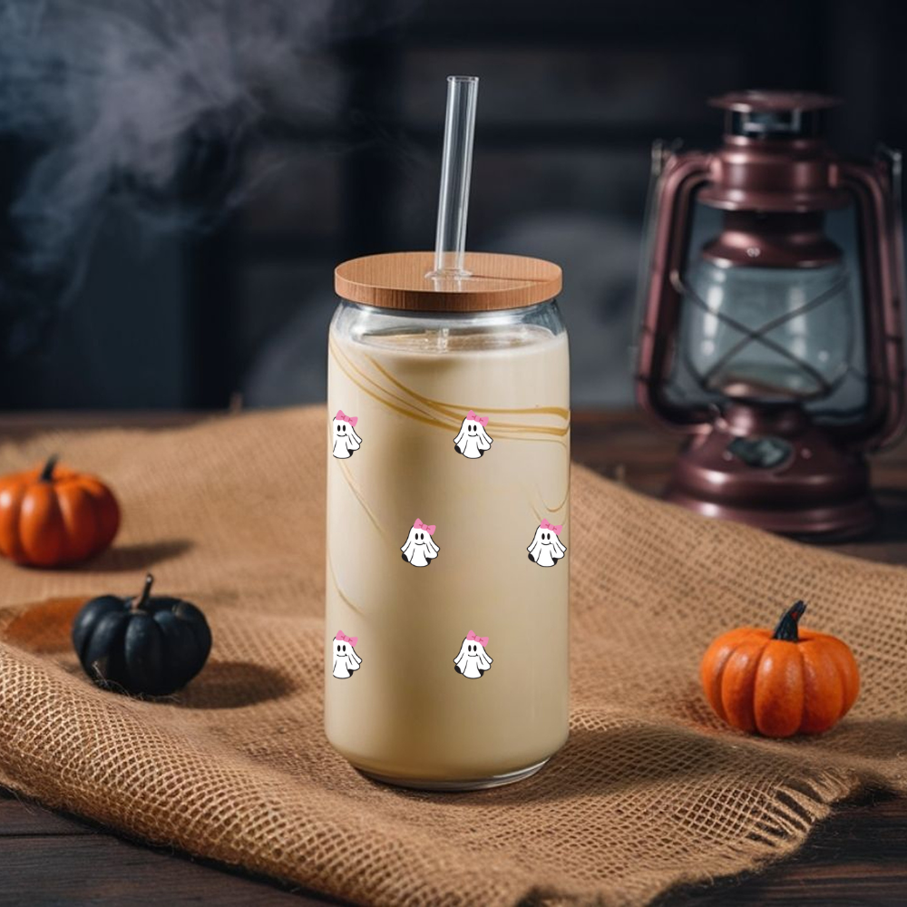 Glass tumbler with a wooden lid and straw on a rustic surface with pumpkins and a lantern.