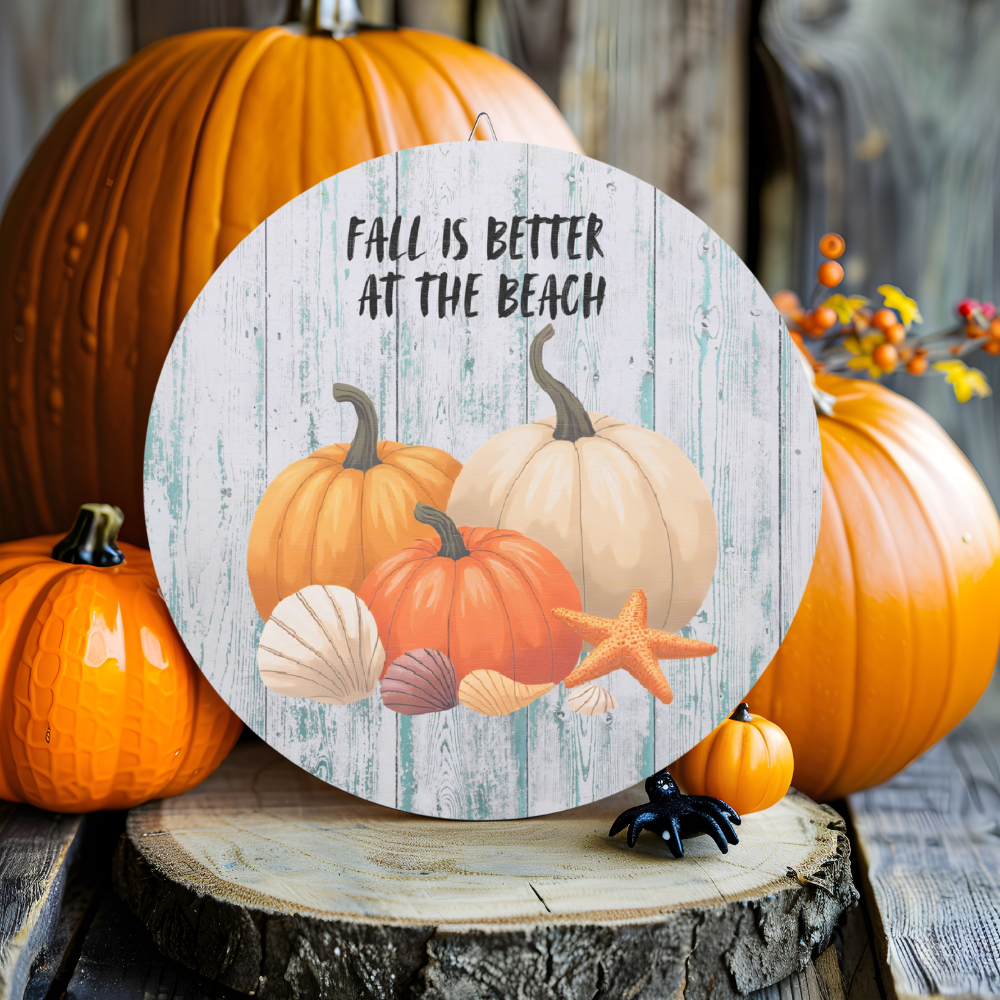 Decorative sign with pumpkins and beach elements on a wooden stump with pumpkins in the background.