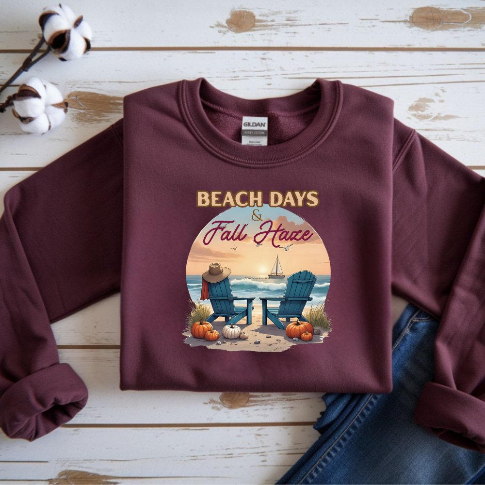 Maroon sweatshirt with 'Beach Days & Fall Have' design on a wooden surface