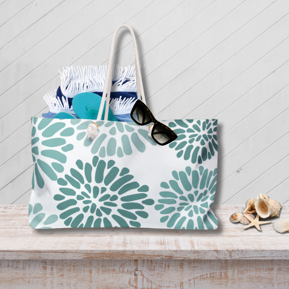Tote bag with green floral pattern on a wooden surface with a white background