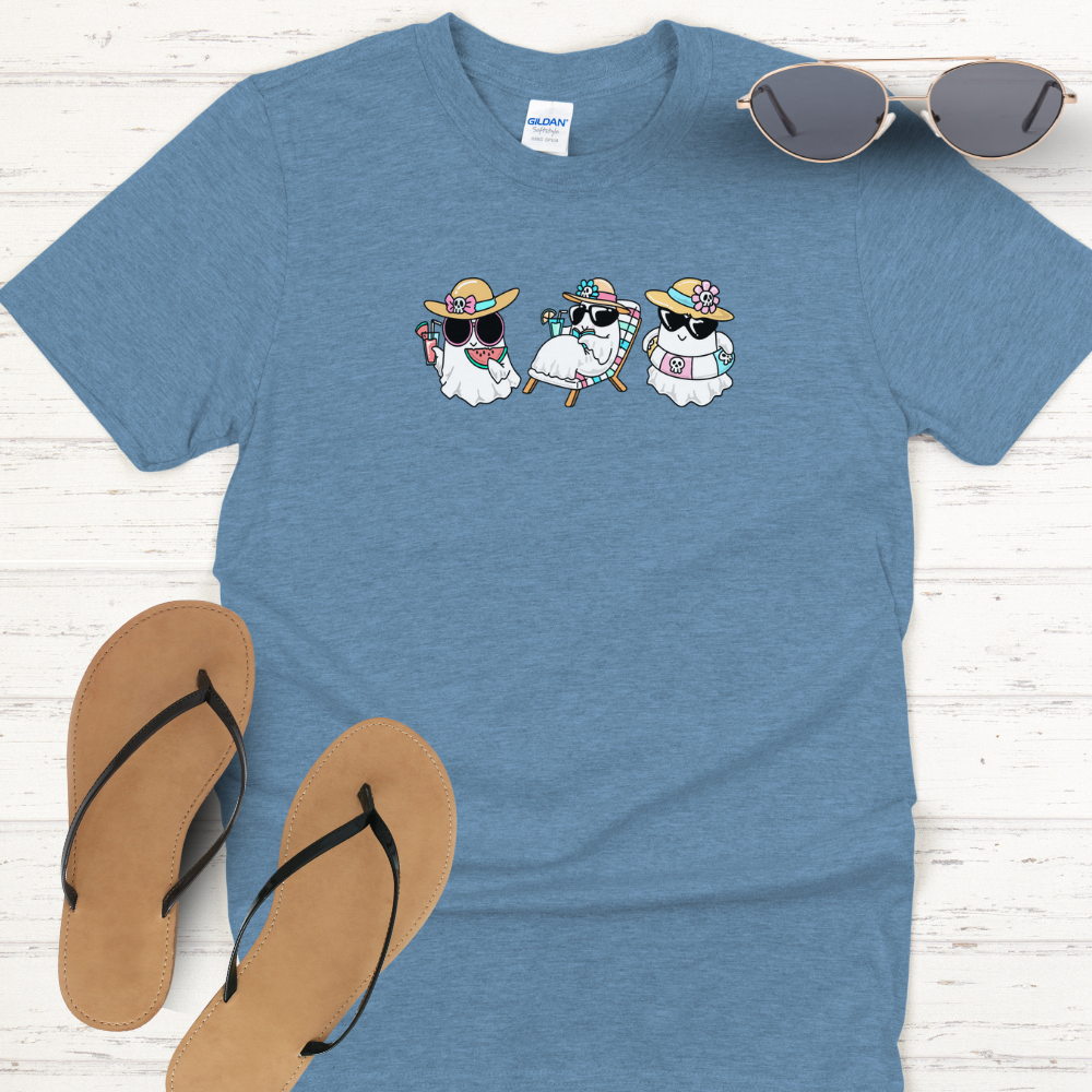 Blue t-shirt with cartoon penguins design, sunglasses, and flip-flops on a wooden surface
