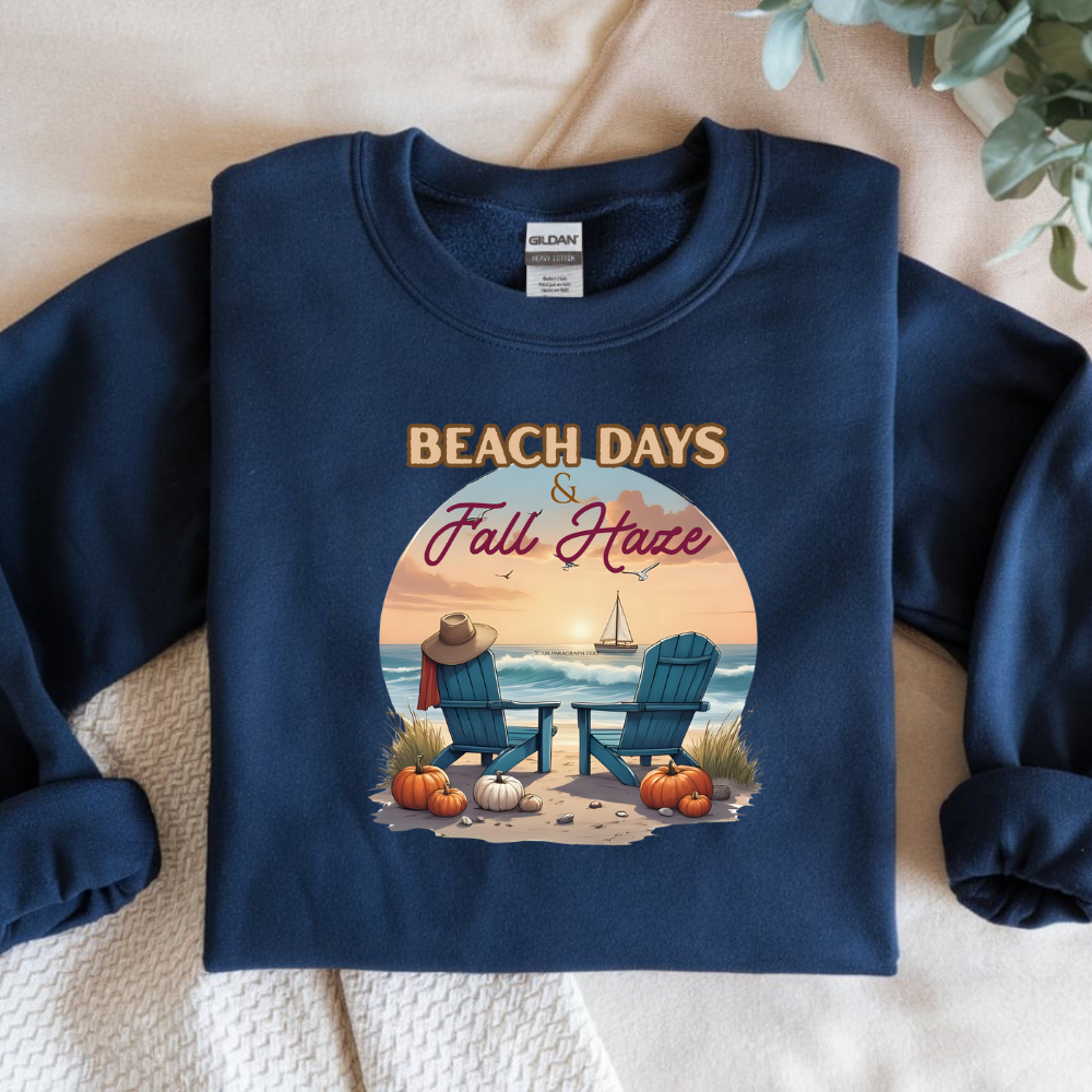 Navy blue sweatshirt with 'Beach Days & Fall Have' design on a textured surface.