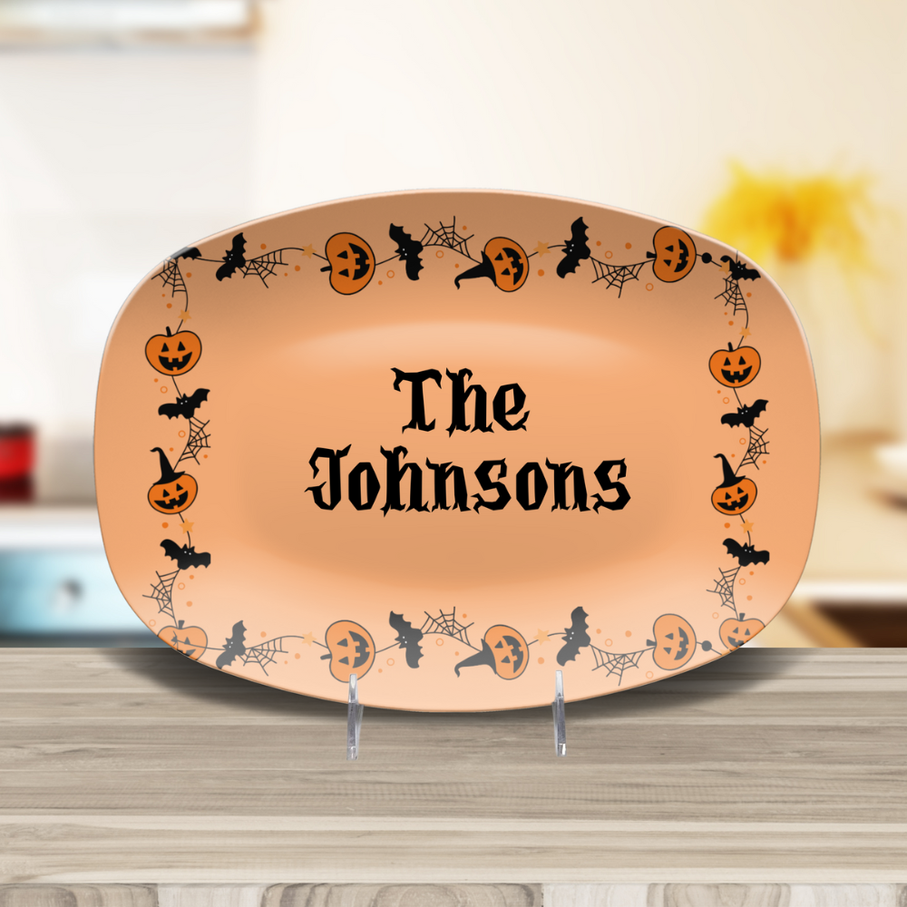 Halloween-themed platter with decorative border and 'The Johnsons' text on a wooden surface.