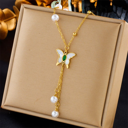 Close-up of nature-inspired 18K gold necklaces with thick chains and delicate charms

