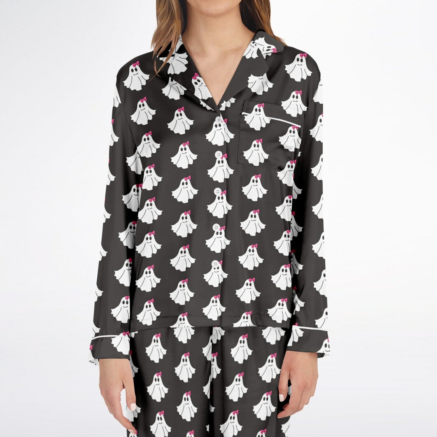Black pajama top with ghost pattern worn by a person on a white background