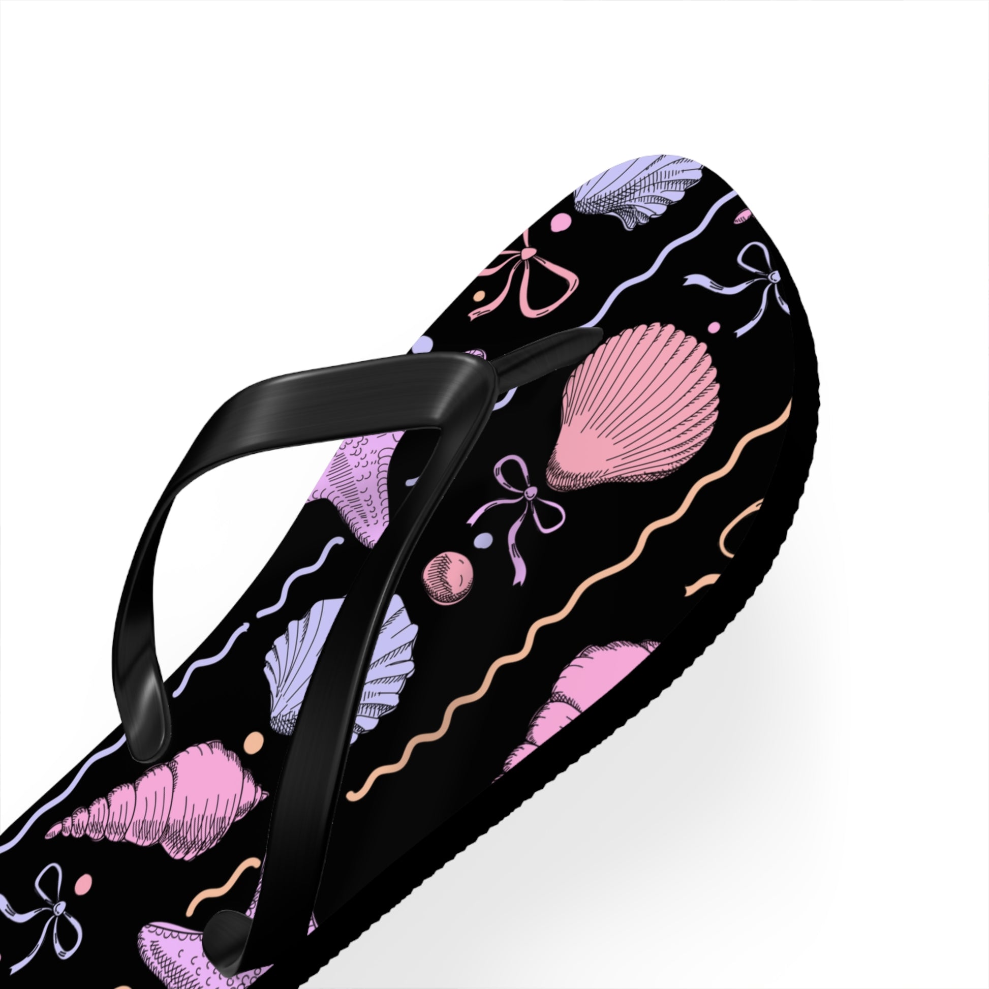 Flip-flop with pink shell and bow design on a black background