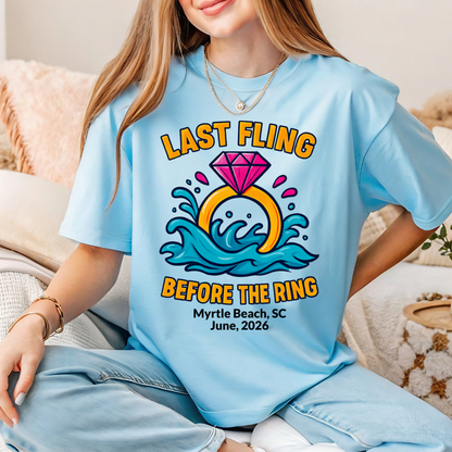 Person wearing a light blue t-shirt with a wedding-themed design and text.
