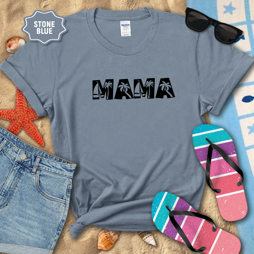 Stone blue t-shirt with 'MAMA' text on a sandy surface with beach accessories.