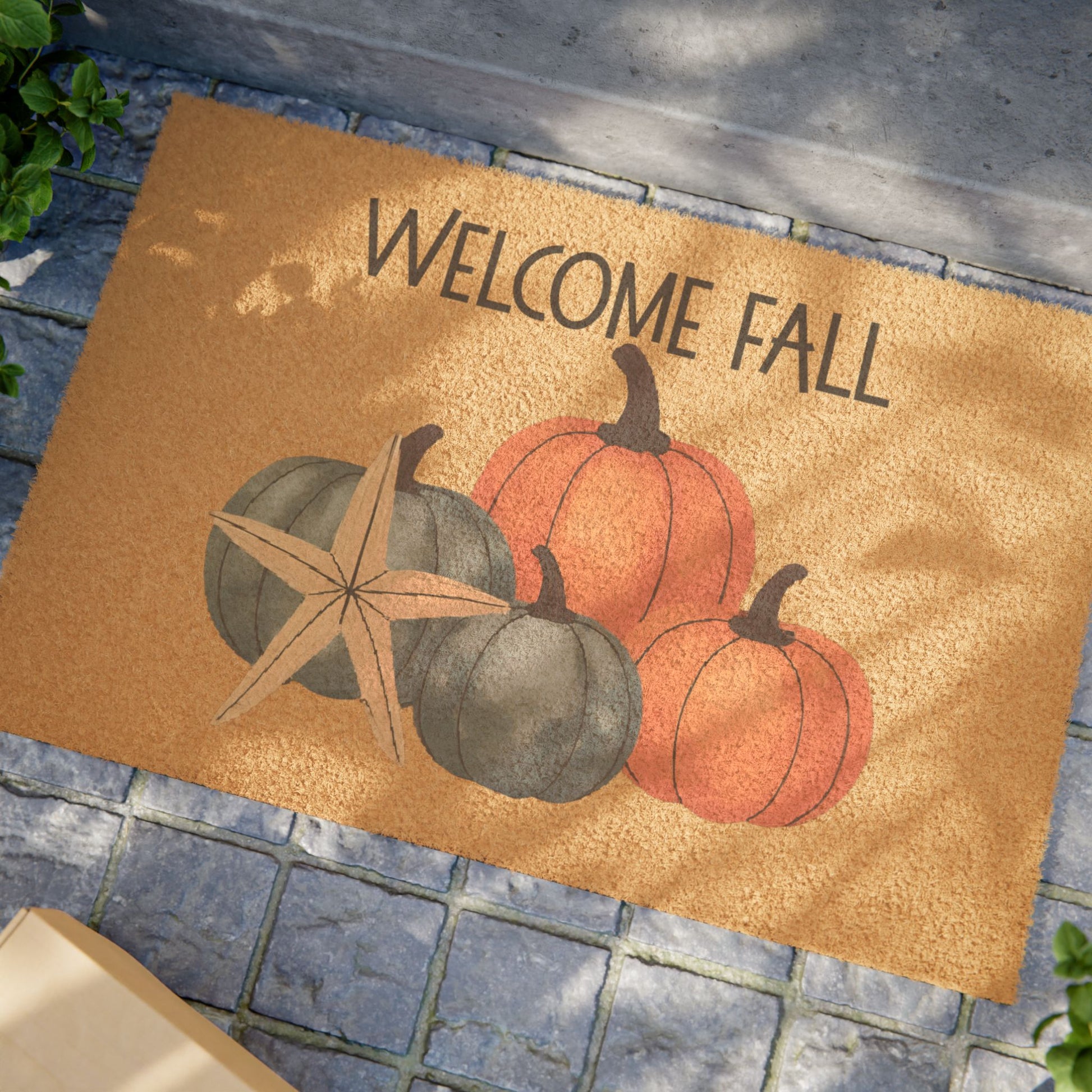 Doormat with pumpkins and 'Welcome Fall' text on a stone surface