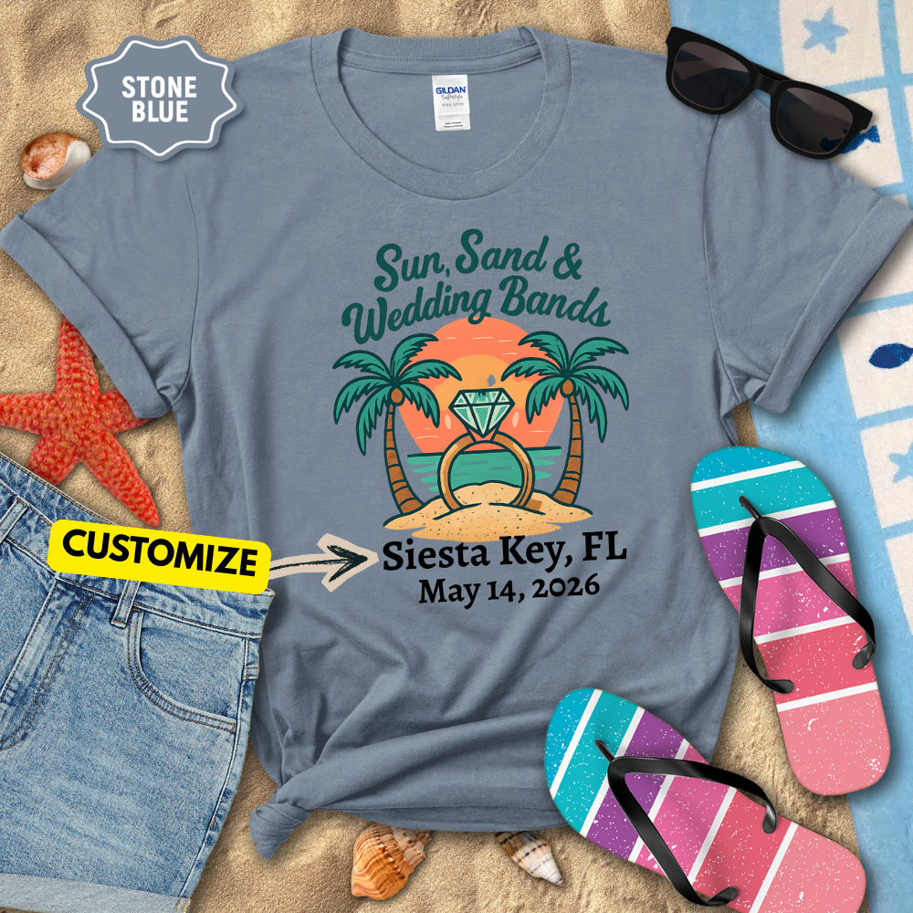 Stone blue t-shirt with tropical design and customizable text on a beach-themed background