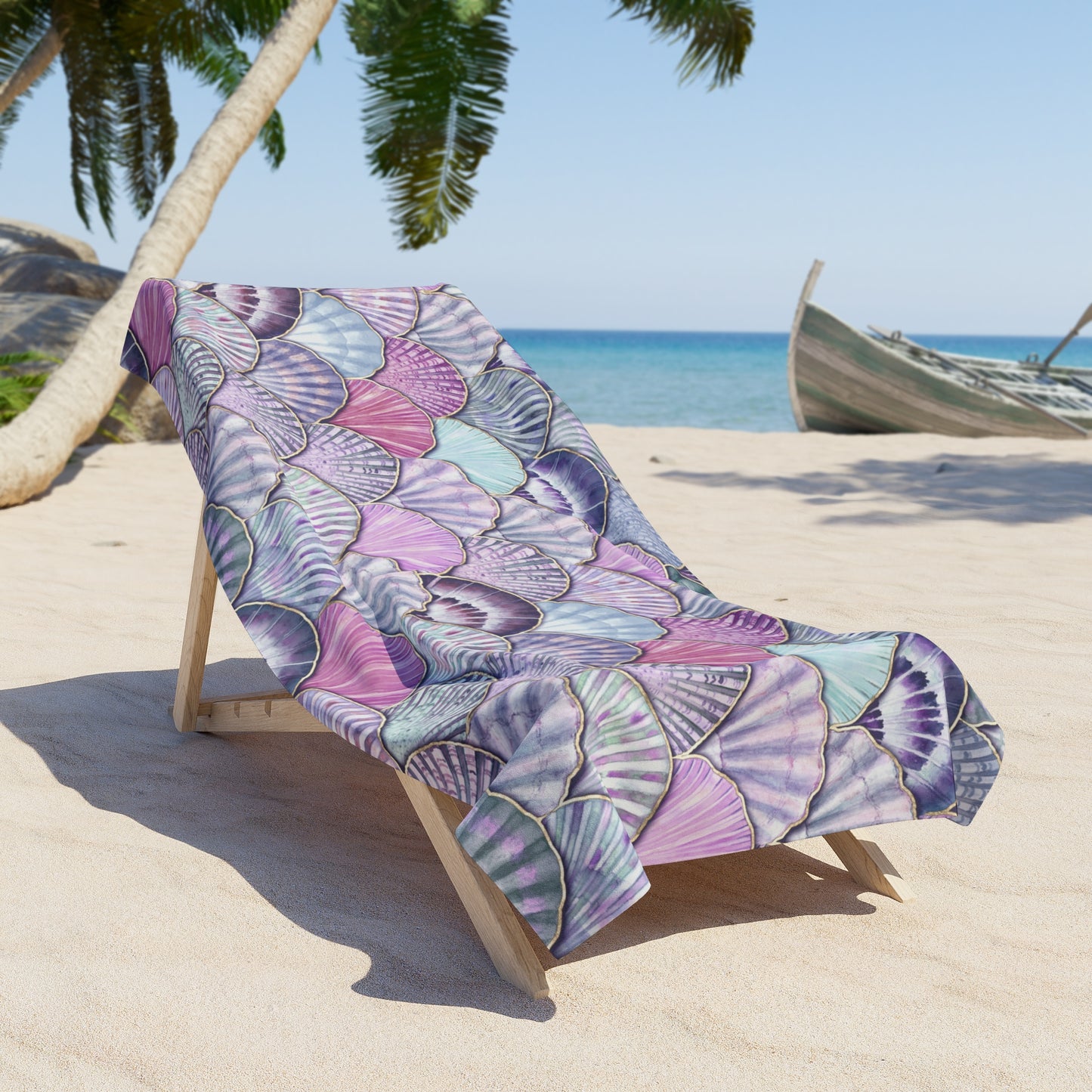 Colorful leaf-patterned towel draped over a beach chair on a sandy beach with palm trees and a boat in the background.