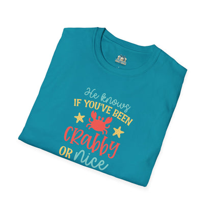 Folded teal t-shirt with colorful text and graphics on a white background