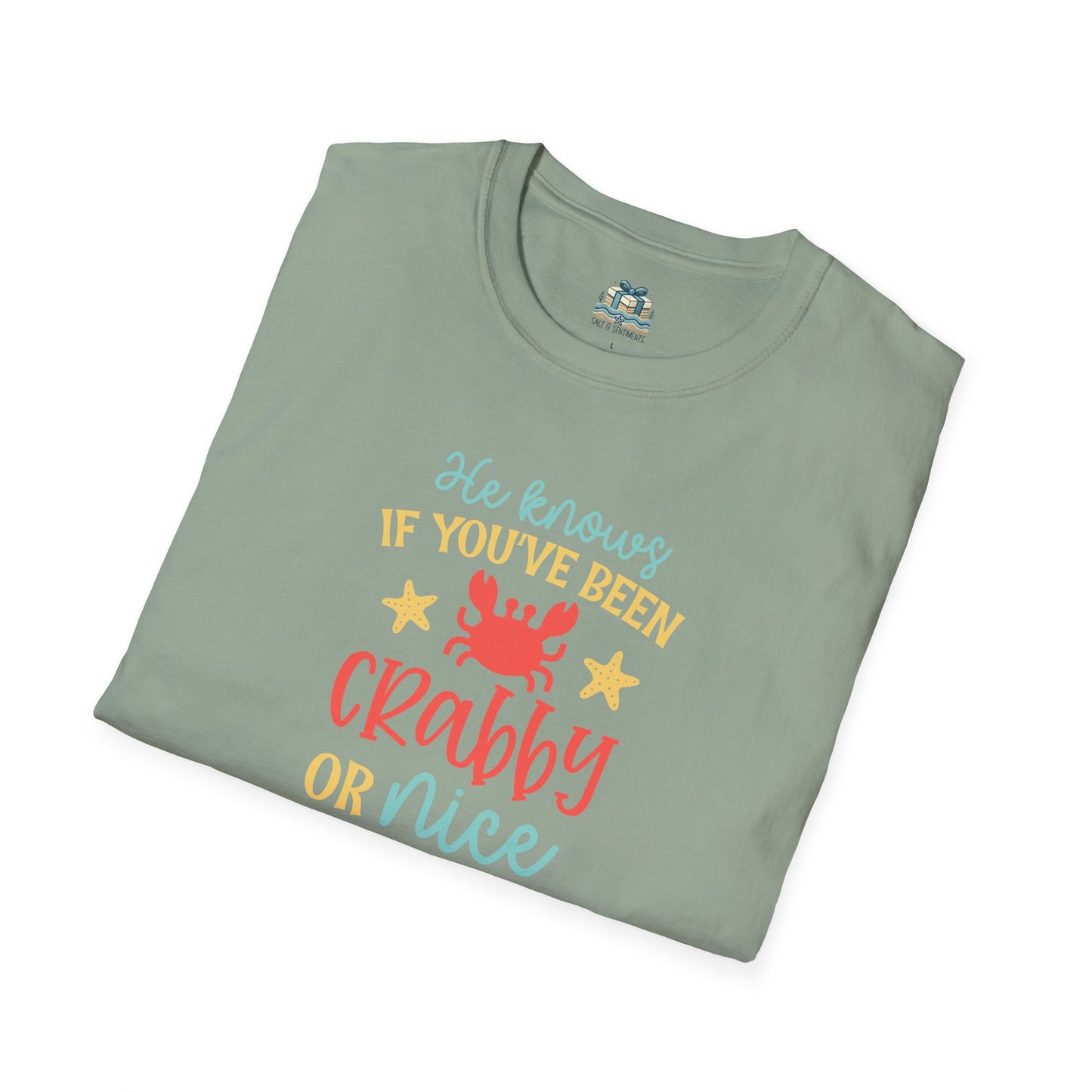 Folded green t-shirt with colorful text and graphics on a white background