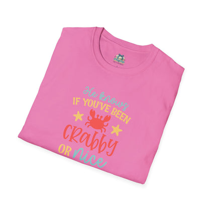 Folded pink t-shirt with colorful text and a crab graphic on a white background
