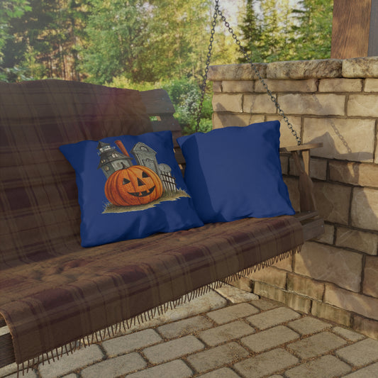 Wooden porch swing with blue pillows featuring Halloween designs, set against a stone wall and greenery.