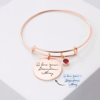 Personalized charm bracelet engraved with names and birthstones

