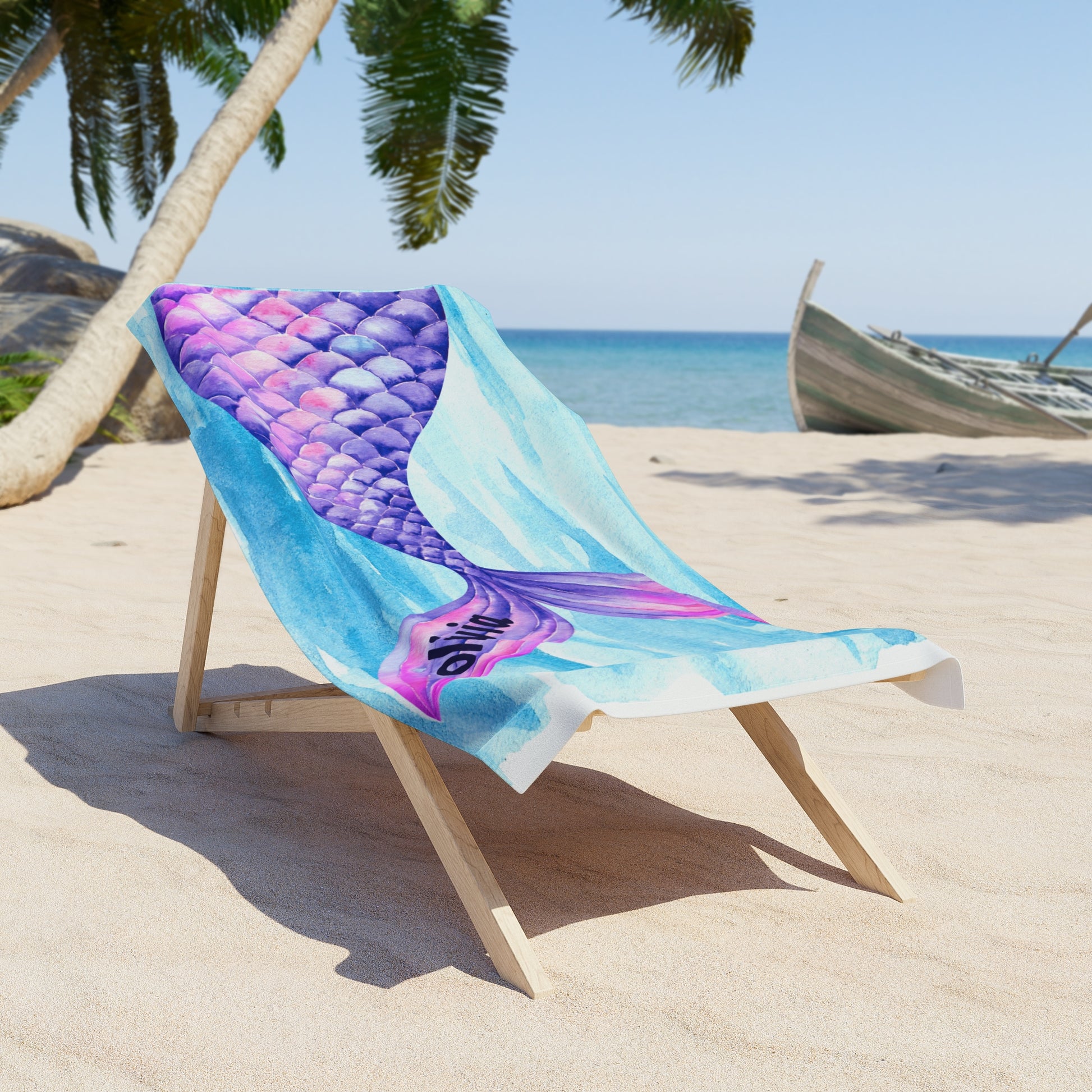 Beach towel with mermaid scale design on a wooden chair at the beach