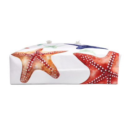 Bottom side of beach bag featuring colorful fish pattern on a deep blue background with white handles, size 18x18 inches.

