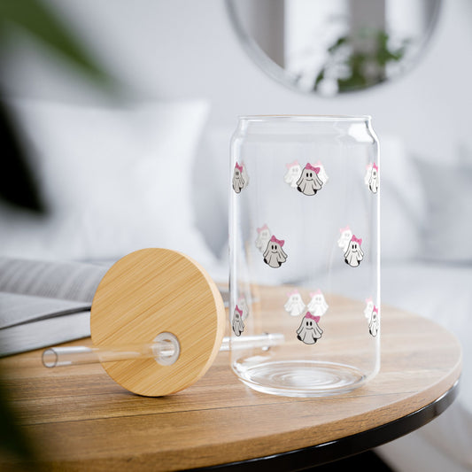 Clear glass tumbler with cartoon designs on a wooden table