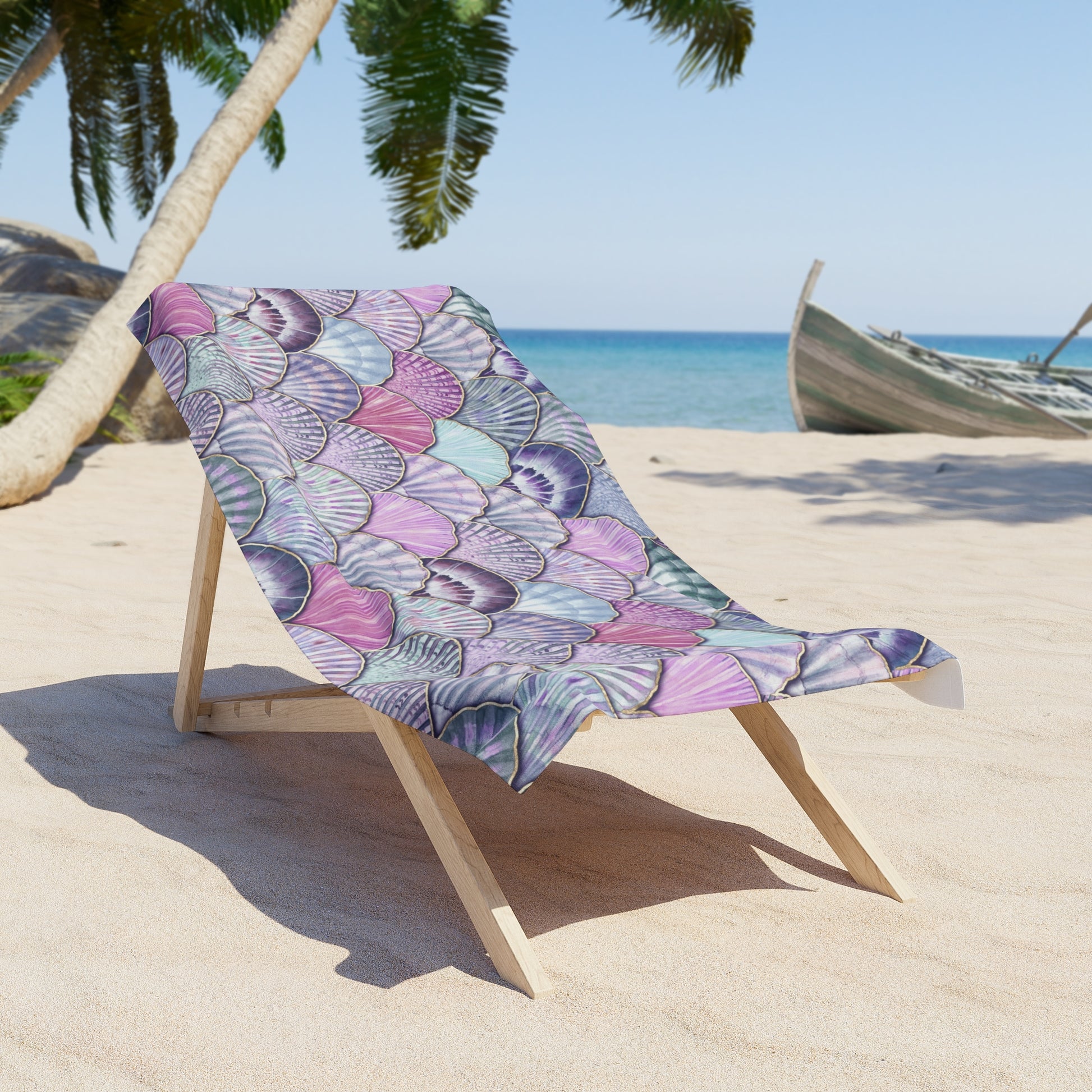 Beach chair with a colorful towel on a sandy beach with palm trees and ocean in the background