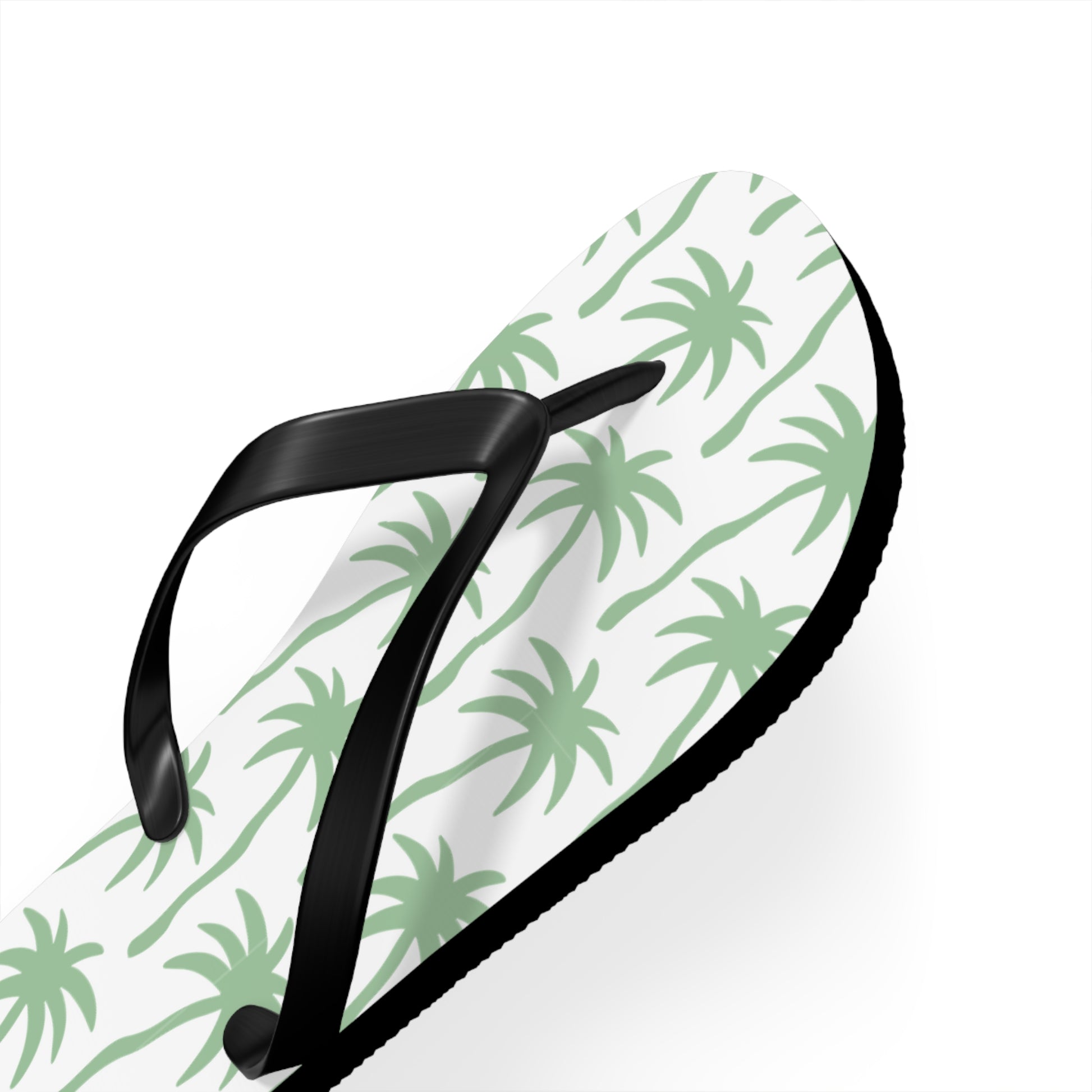 Black flip-flop with green palm tree pattern on a white background