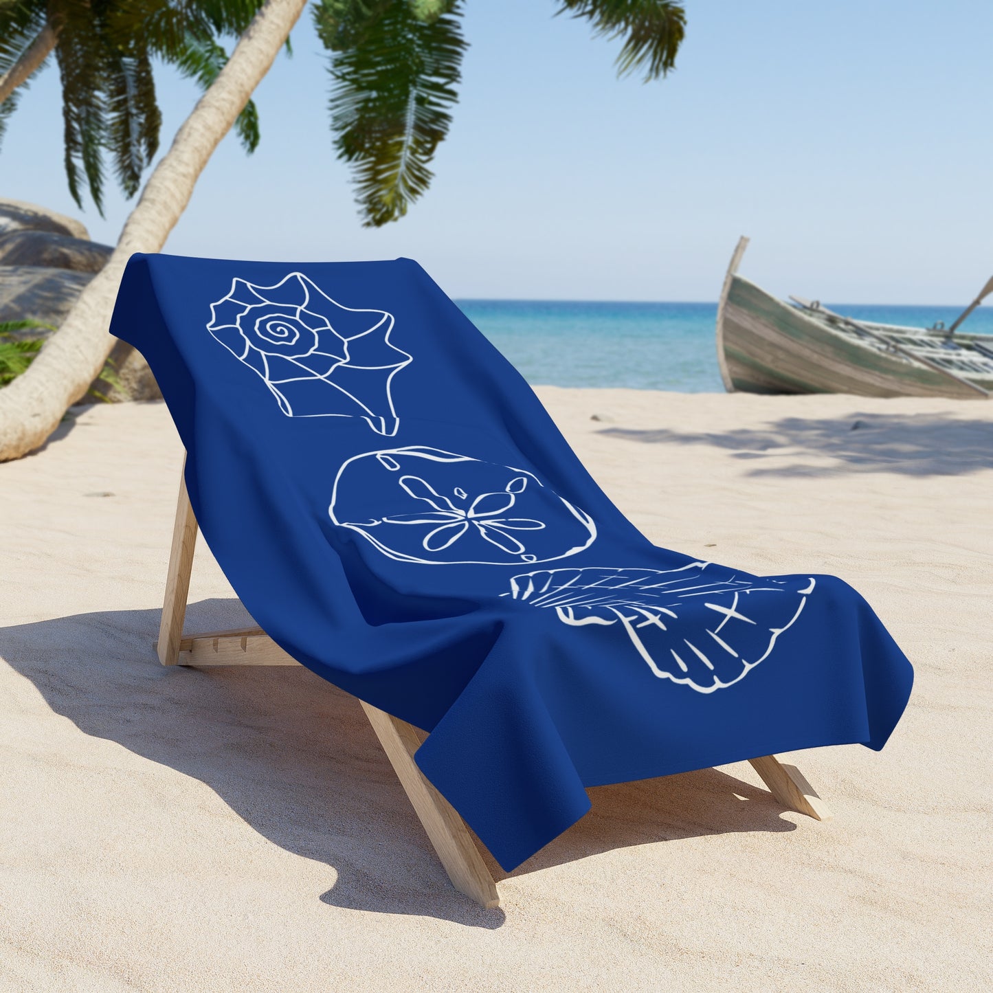 Blue towel with white designs on a beach chair by the ocean
