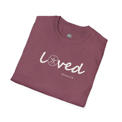 Folded maroon t-shirt with 'loved' text on a white background