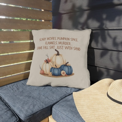 Decorative pillow with pumpkins and text on a bench outdoors