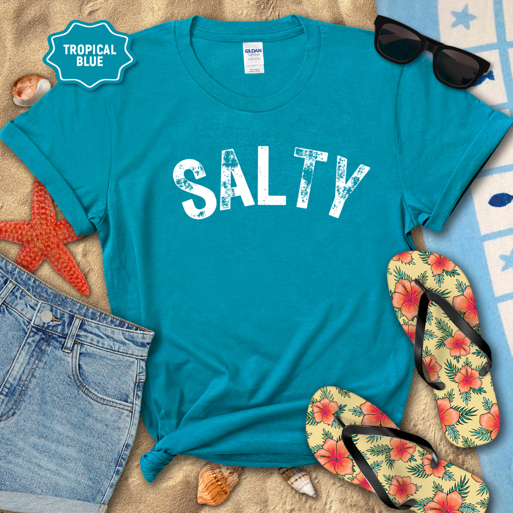 Blue t-shirt with 'SALTY' text on a beach-themed background with sunglasses, flip-flops, and starfish.