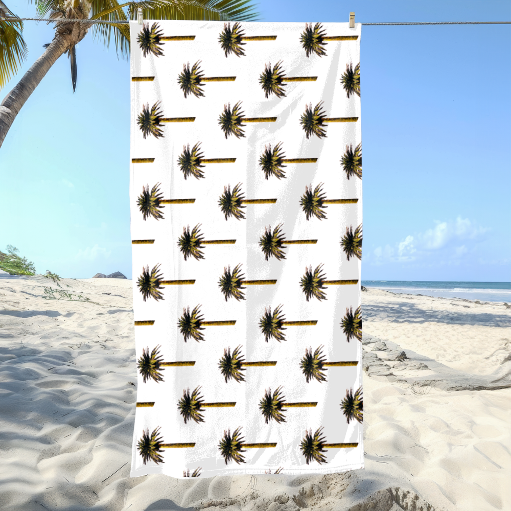 Towel with palm tree pattern on a beach