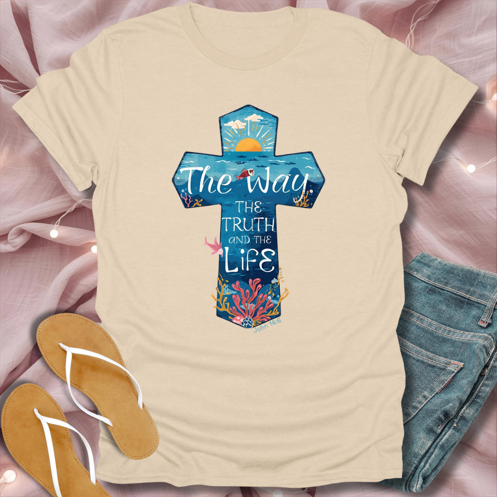 Beige t-shirt with a colorful cross design on a pink fabric background
