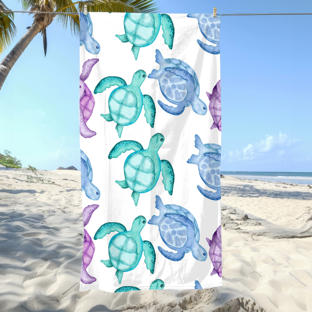 Beach towel with turtle pattern on a sandy beach with palm trees