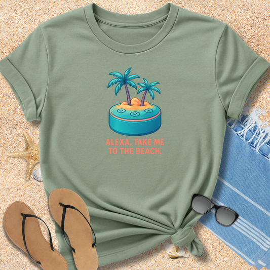 Green t-shirt with beach graphic and text on sand with flip-flops and towel.