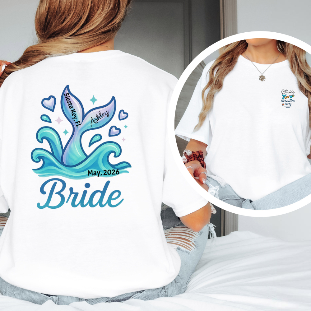 White t-shirt with blue mermaid design and text on the back, worn by a person.