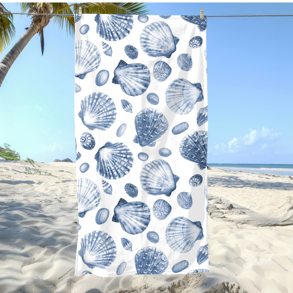 Towel with blue shell pattern on a beach