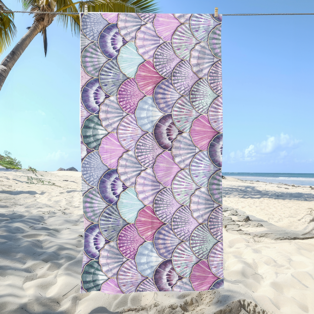Towel with shell pattern hanging on a beach