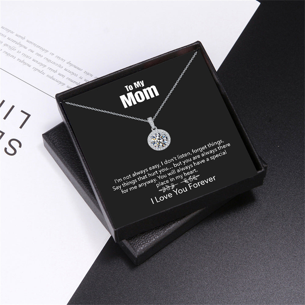 Necklace in a black box with personalized message for mom on a white and black background