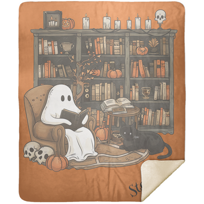 Blanket with a ghost reading a book and a black cat in front of a bookshelf on an orange background.
