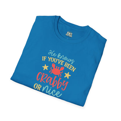 Folded blue t-shirt with colorful text and graphics on a white background