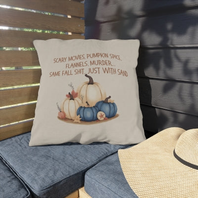 Decorative pillow with pumpkins and text on a bench outdoors