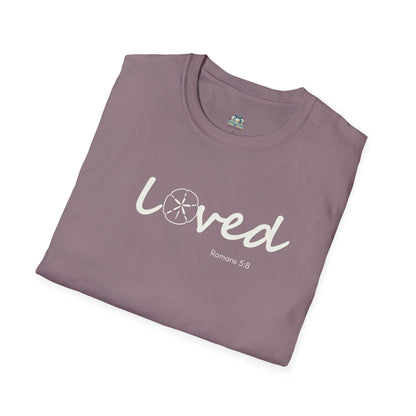 Folded purple t-shirt with 'loved' text on a white background