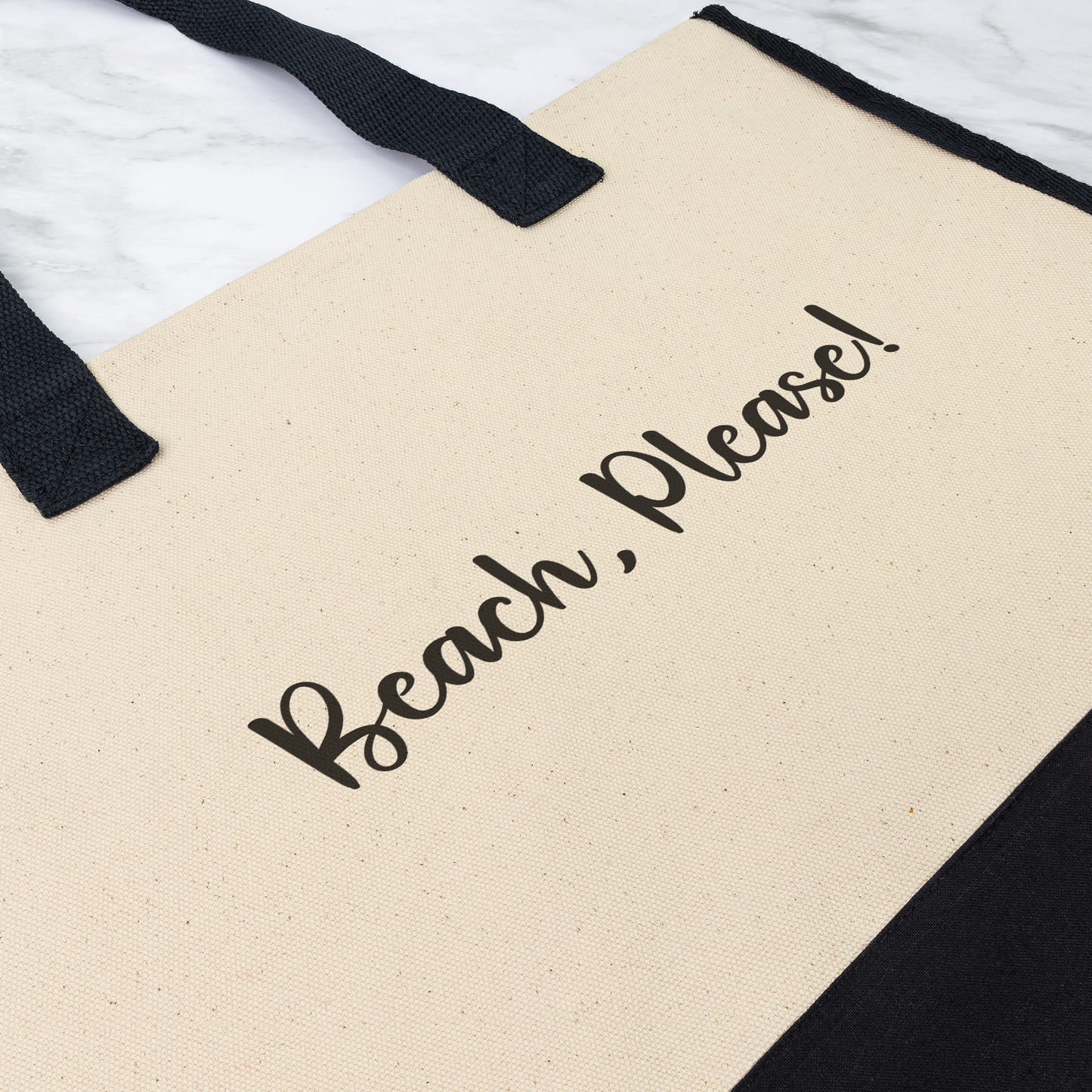 Beige tote bag with 'Beach, Please!' text and black handles on a white background