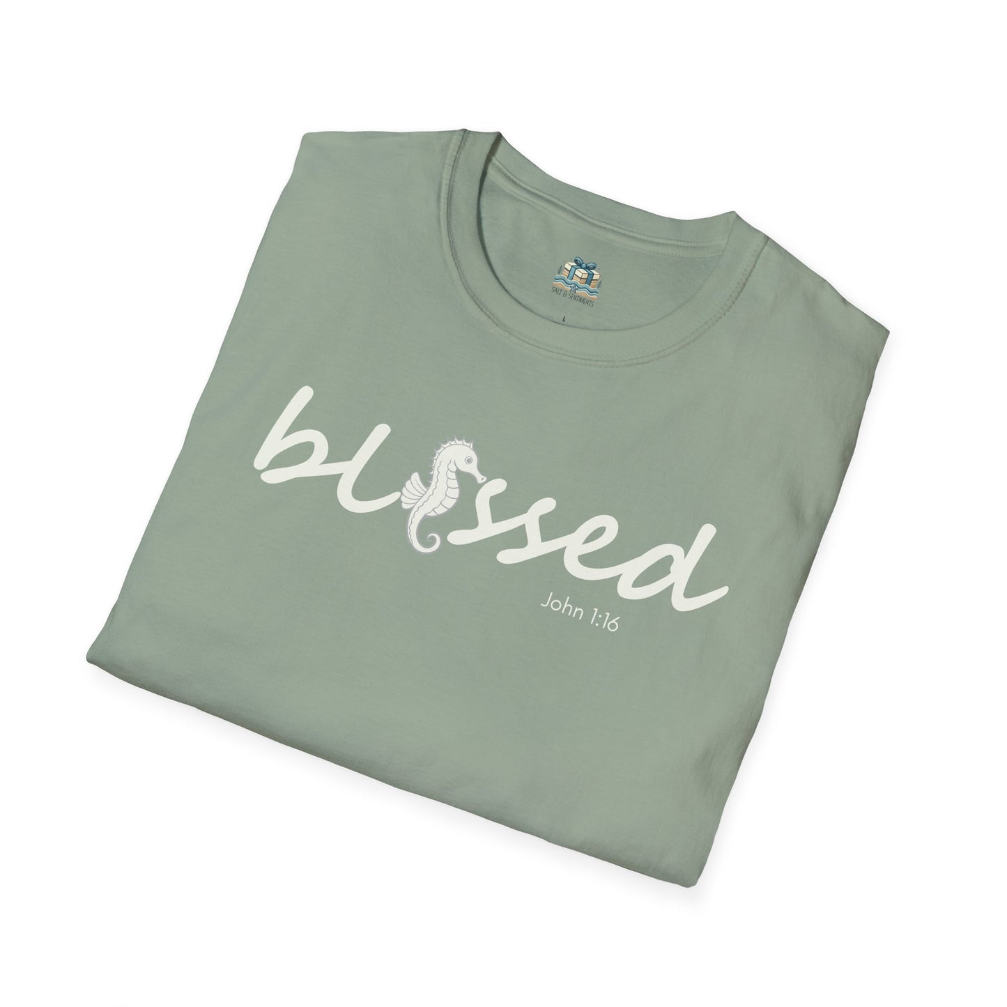 Folded green t-shirt with 'blessed' text on a white background