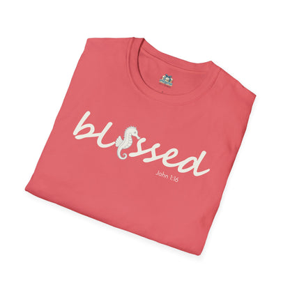 Folded pink t-shirt with 'blessed' text on a white background